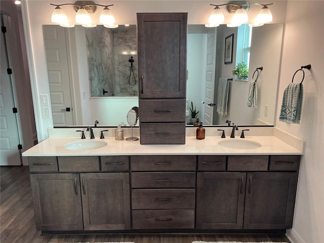 bathroom featuring walk in shower, vanity, and hardwood / wood-style floors