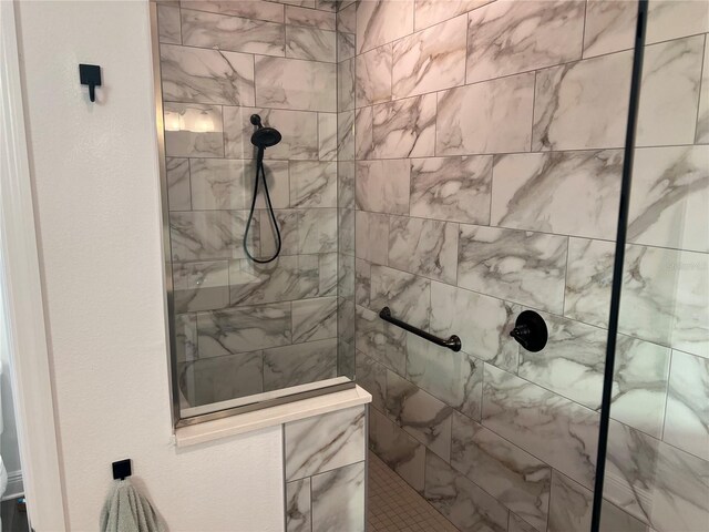 bathroom with tiled shower