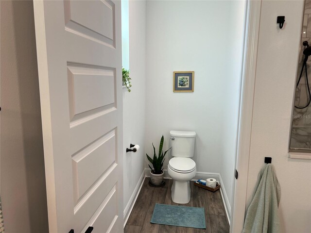 bathroom featuring toilet and wood-type flooring