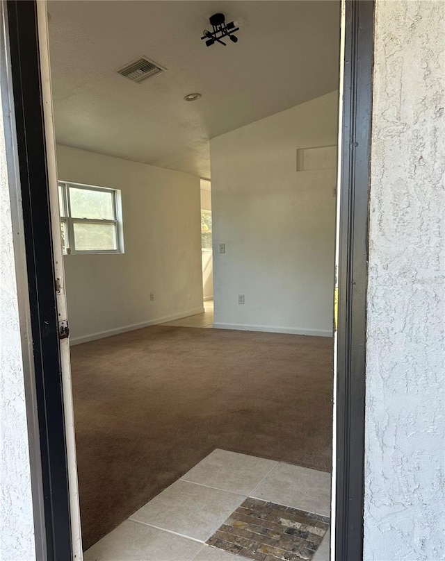 empty room featuring light colored carpet