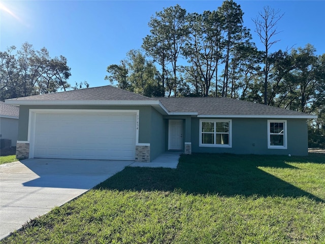 single story home featuring a garage, a front lawn, and central AC