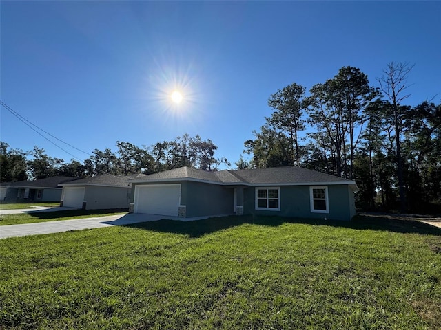 single story home featuring a garage and a front lawn