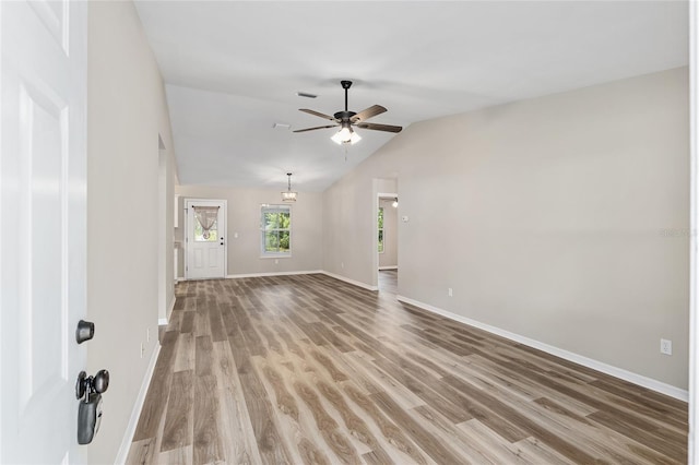 unfurnished living room featuring ceiling fan, hardwood / wood-style floors, and vaulted ceiling