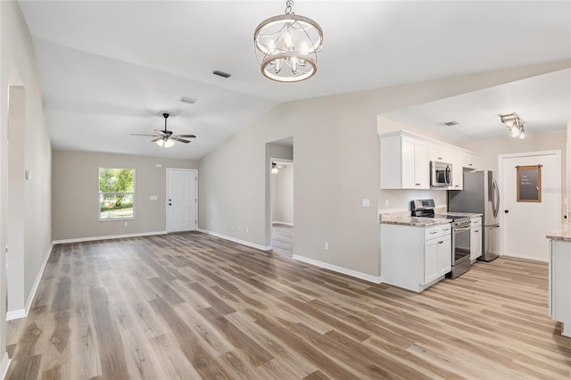 kitchen with light hardwood / wood-style flooring, white cabinets, lofted ceiling, and appliances with stainless steel finishes