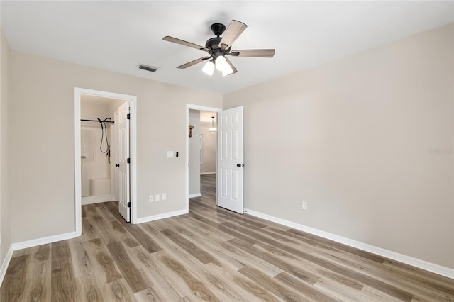 unfurnished bedroom featuring connected bathroom, ceiling fan, and light wood-type flooring