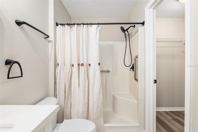 bathroom with toilet, wood-type flooring, vanity, and a shower with curtain