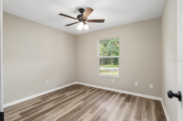 empty room featuring hardwood / wood-style floors and ceiling fan