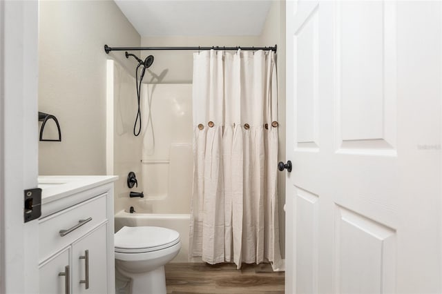 full bathroom with toilet, shower / bath combination with curtain, hardwood / wood-style flooring, and vanity