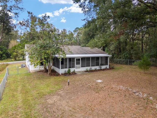 view of front of property featuring a front yard and a sunroom