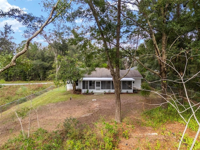 single story home featuring a sunroom