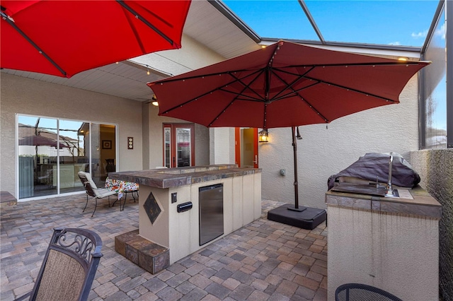 view of patio / terrace with an outdoor bar and exterior kitchen