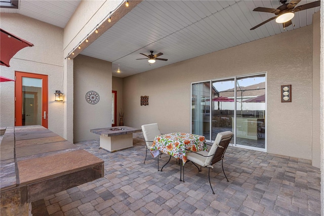 view of patio / terrace with an outdoor fire pit and ceiling fan