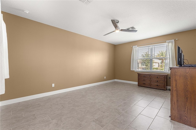 unfurnished bedroom featuring a textured ceiling, ceiling fan, and light tile patterned floors