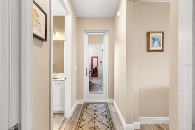 corridor featuring light hardwood / wood-style floors