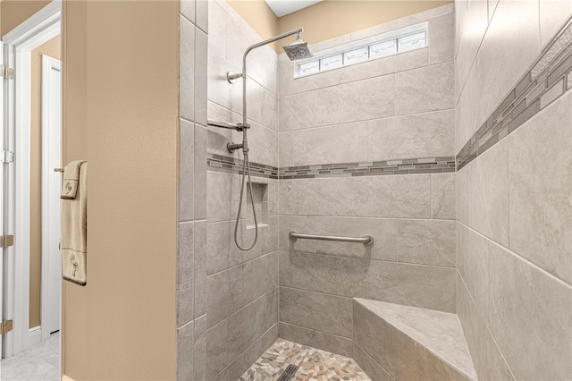 bathroom featuring tiled shower