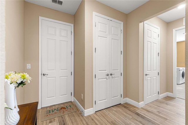 entryway featuring light wood-type flooring and washer / clothes dryer