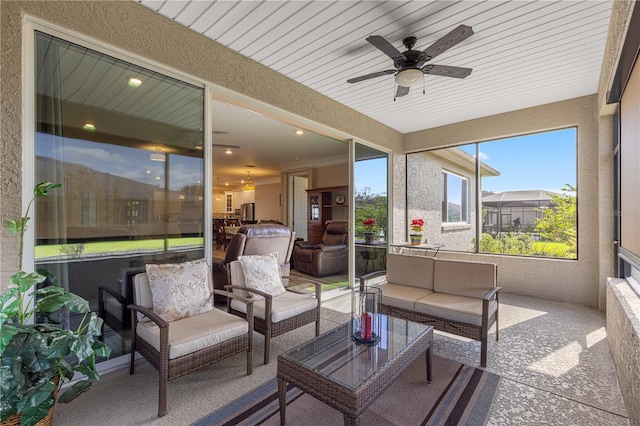 sunroom with ceiling fan and wood ceiling