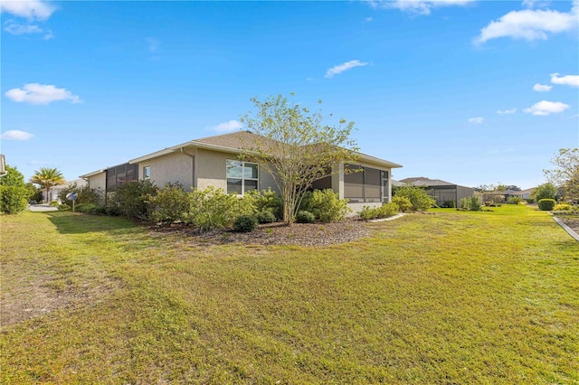 view of property exterior with a sunroom and a yard