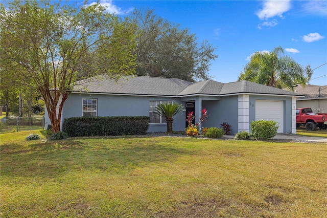 ranch-style house with a garage and a front lawn