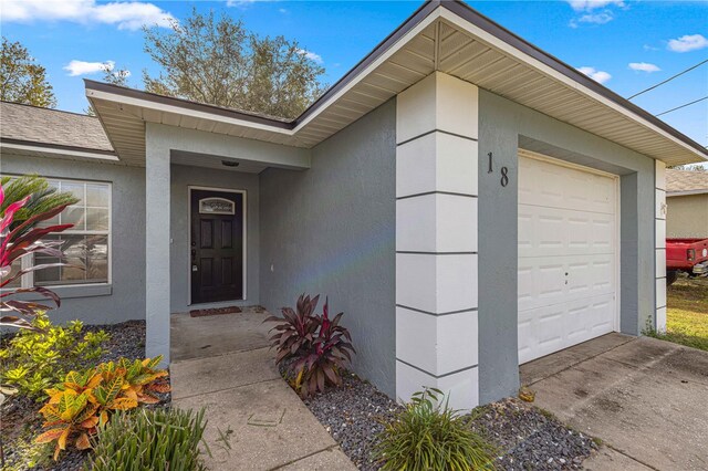 doorway to property featuring a garage