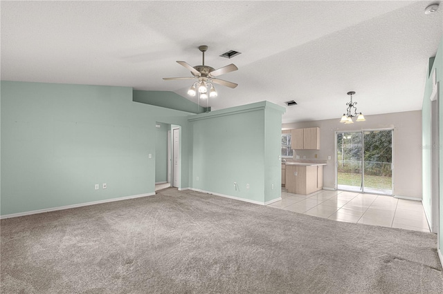 unfurnished living room featuring a textured ceiling, ceiling fan with notable chandelier, light carpet, and vaulted ceiling