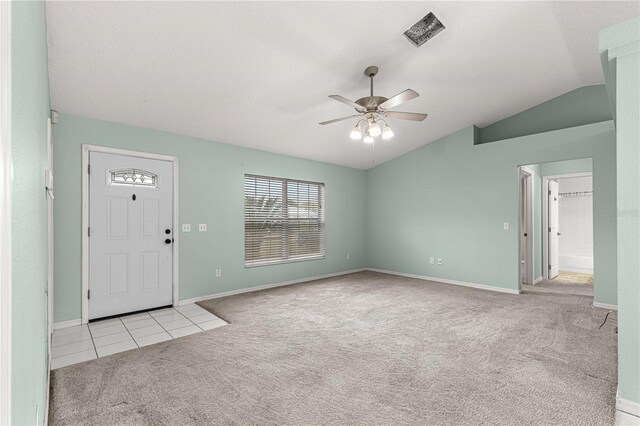 entrance foyer featuring vaulted ceiling, light carpet, and ceiling fan