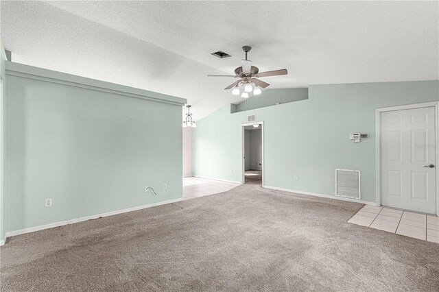 unfurnished living room featuring a textured ceiling, carpet, lofted ceiling, and ceiling fan