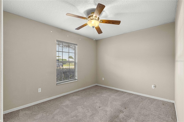 carpeted spare room with a textured ceiling and ceiling fan