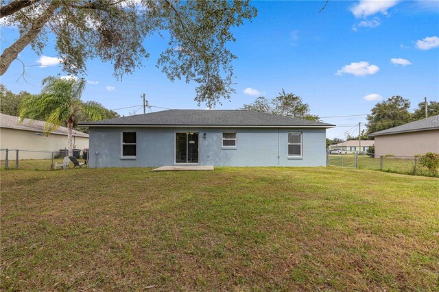 back of house with a yard