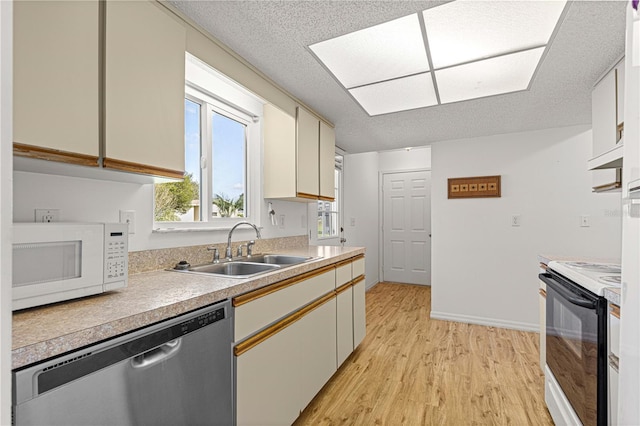 kitchen with light hardwood / wood-style floors, sink, a textured ceiling, dishwasher, and electric range