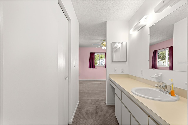 bathroom featuring vanity, a textured ceiling, and ceiling fan