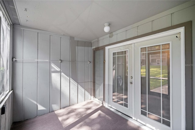 unfurnished sunroom with french doors