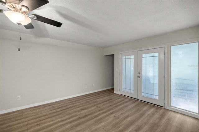 unfurnished bedroom with access to exterior, french doors, hardwood / wood-style flooring, and ceiling fan