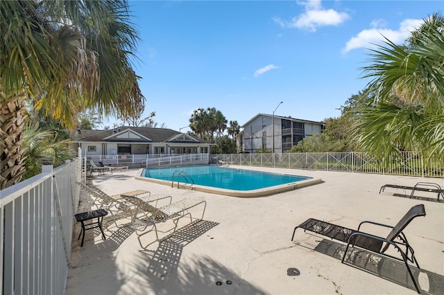 view of swimming pool with a patio area