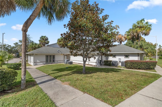 single story home with central AC unit and a front lawn