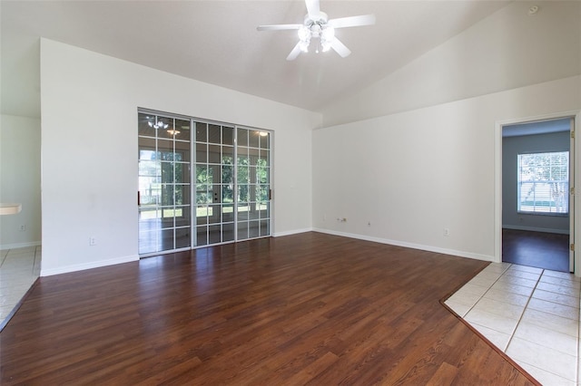 empty room with hardwood / wood-style flooring, vaulted ceiling, and ceiling fan