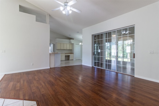 unfurnished living room featuring ceiling fan, wood-type flooring, and vaulted ceiling