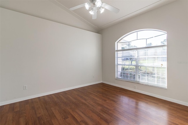 unfurnished room featuring ceiling fan, dark hardwood / wood-style flooring, and vaulted ceiling