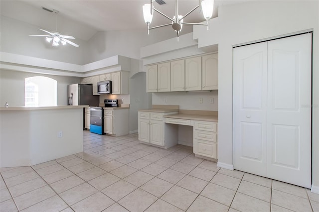 kitchen featuring ceiling fan with notable chandelier, stainless steel appliances, light tile patterned floors, high vaulted ceiling, and hanging light fixtures