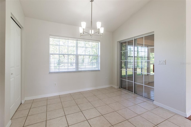 unfurnished dining area with a notable chandelier, light tile patterned floors, and vaulted ceiling