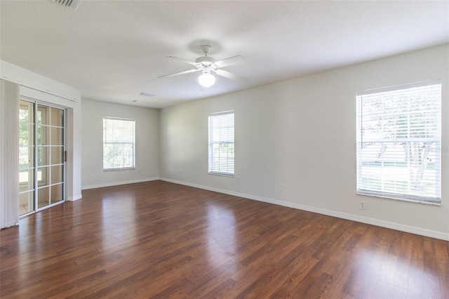 unfurnished room featuring dark hardwood / wood-style floors, ceiling fan, and a textured ceiling