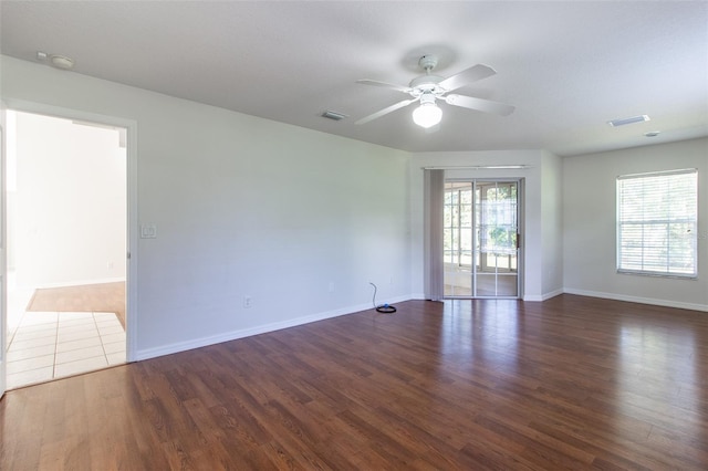 unfurnished room with ceiling fan and dark wood-type flooring