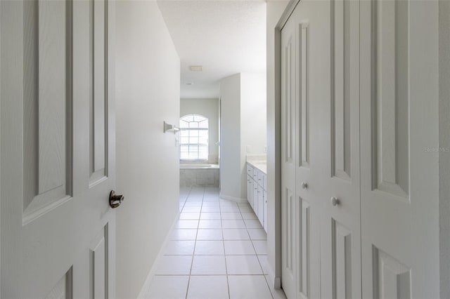 hall featuring light tile patterned flooring