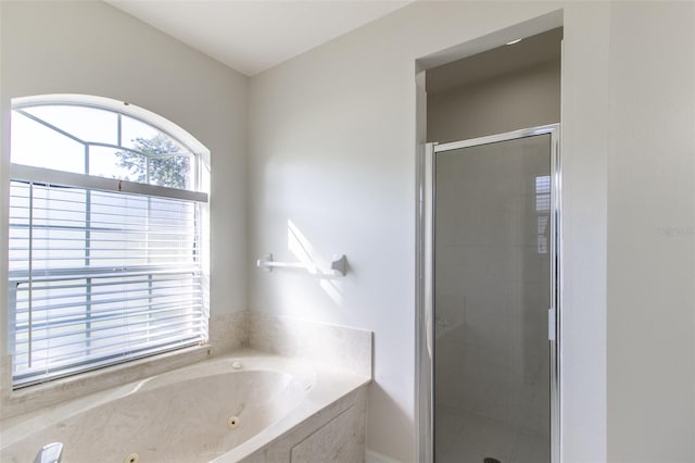 bathroom with shower with separate bathtub