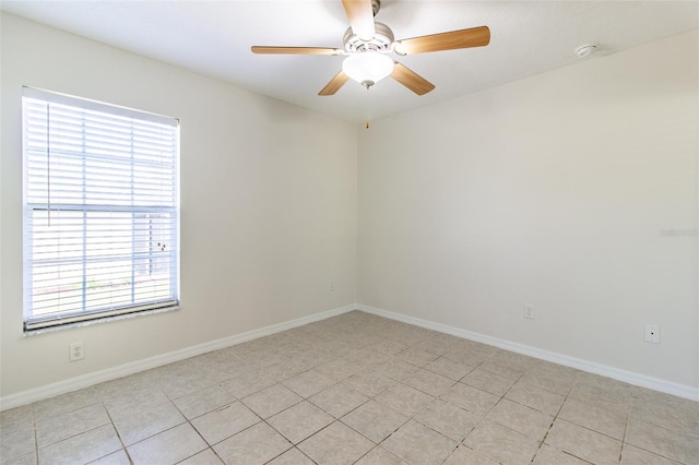 spare room featuring ceiling fan and light tile patterned flooring