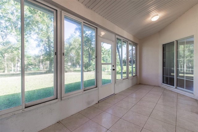 unfurnished sunroom with a wealth of natural light and vaulted ceiling