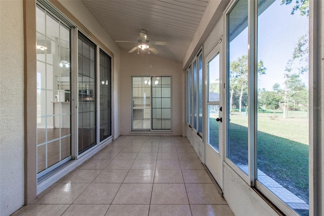 unfurnished sunroom with ceiling fan and lofted ceiling