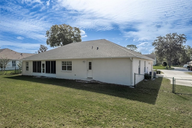 rear view of house featuring a yard