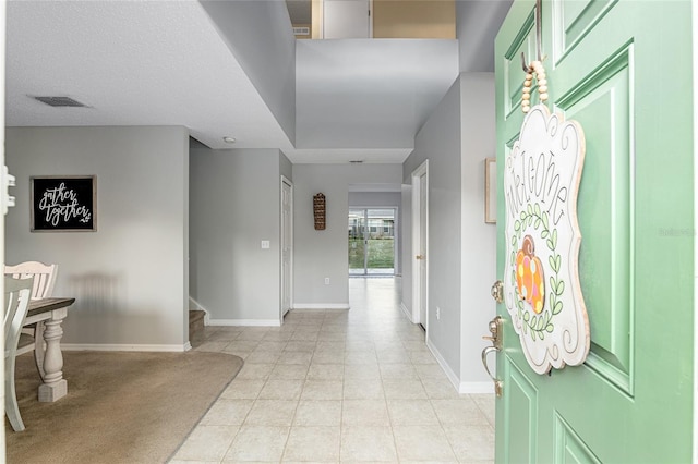 foyer featuring light tile patterned floors