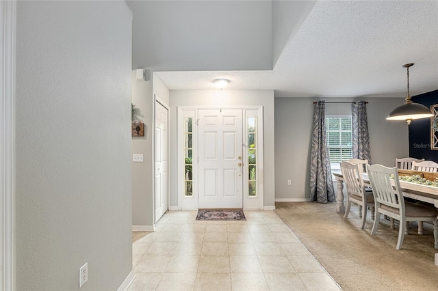 carpeted entrance foyer with a textured ceiling